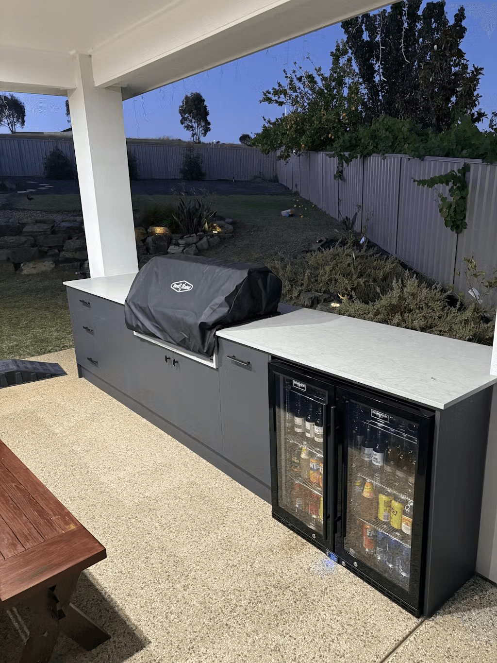 Schmick Black Quiet Running Front Venting Under Bench Heated Glass 2 Door Bar Fridge - Model SK245-B-HD styled in outdoor entertaining setting