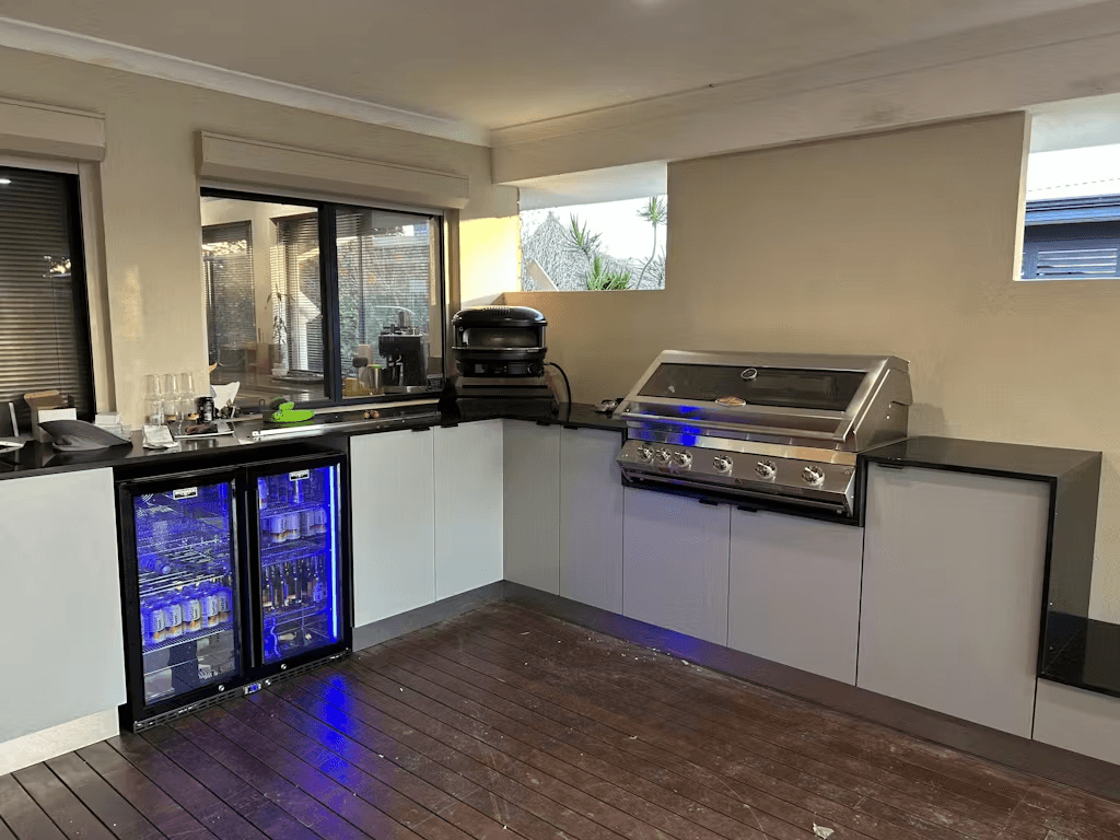 Schmick Black Quiet Running Front Venting Under Bench Heated Glass 2 Door Bar Fridge - Model SK245-B-HD styled in outdoor entertaining setting